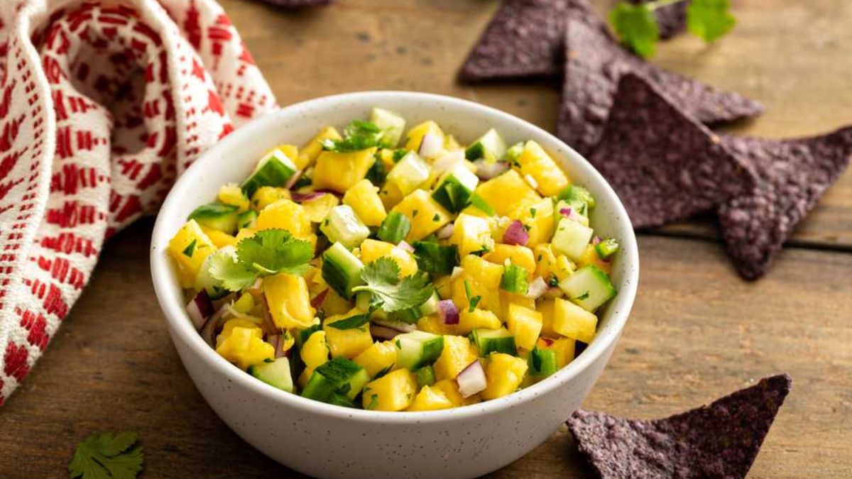 Pineapple salsa in a bowl with chips on the side.