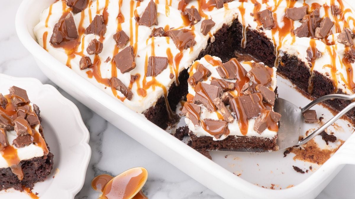 Better than anything cake cut into pieces in baking dish.