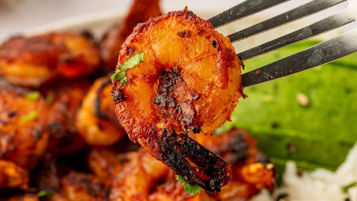 Close up image of blackened shrimp on a fork.