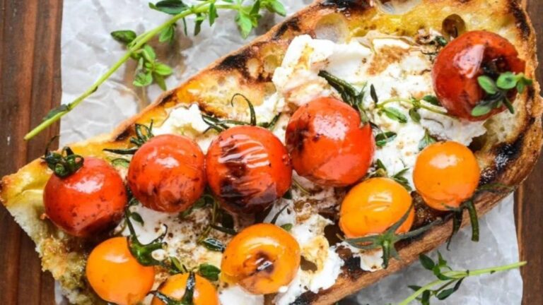 Cherry tomato bruschetta on a piece of parchment paper.