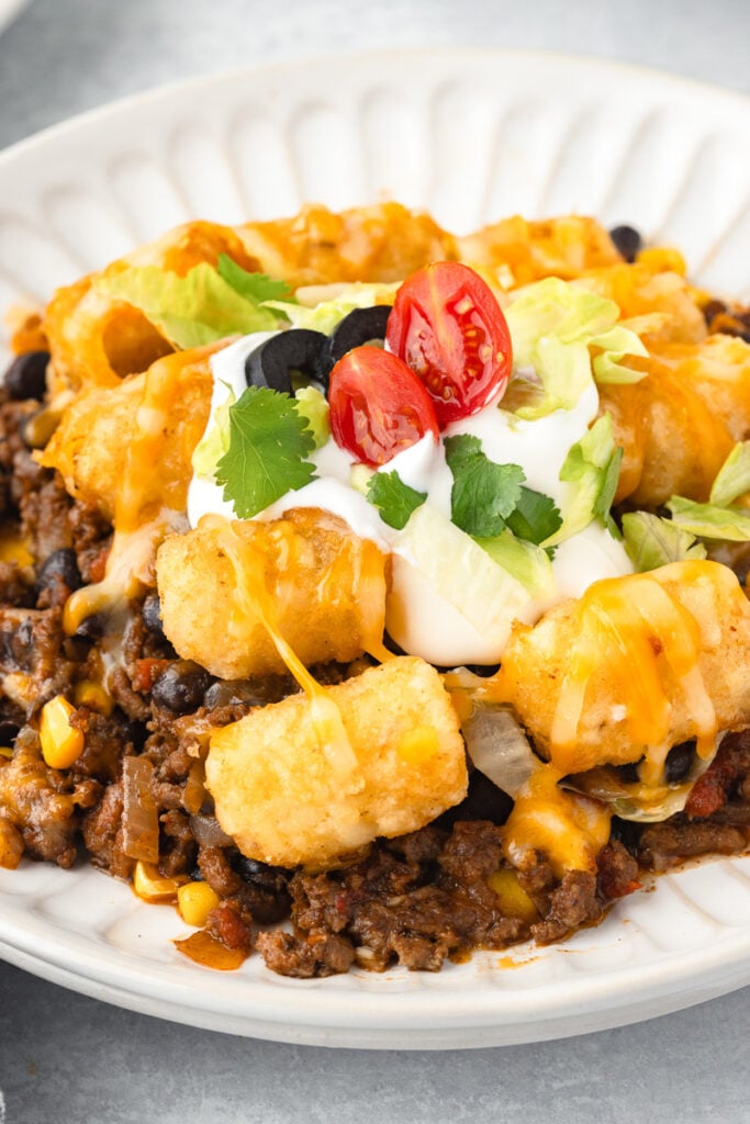 Taco tater tot casserole on a white plate.