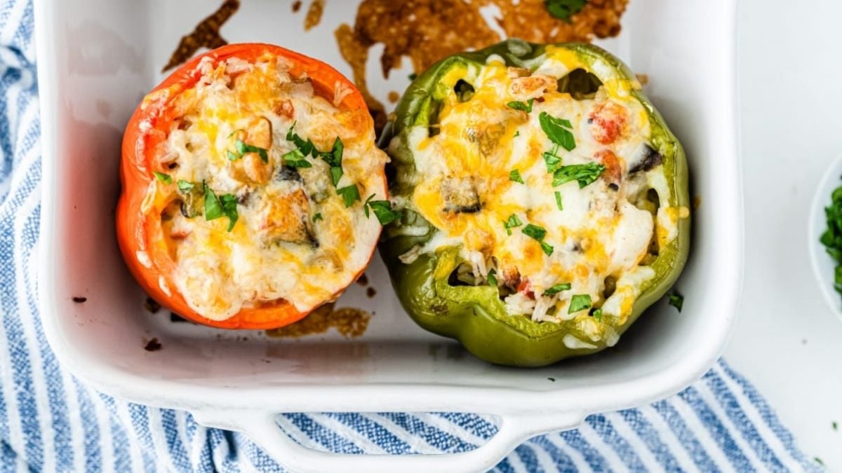 Overhead view of finished ish of shrimp stuffed peppers and rice in baking dish.