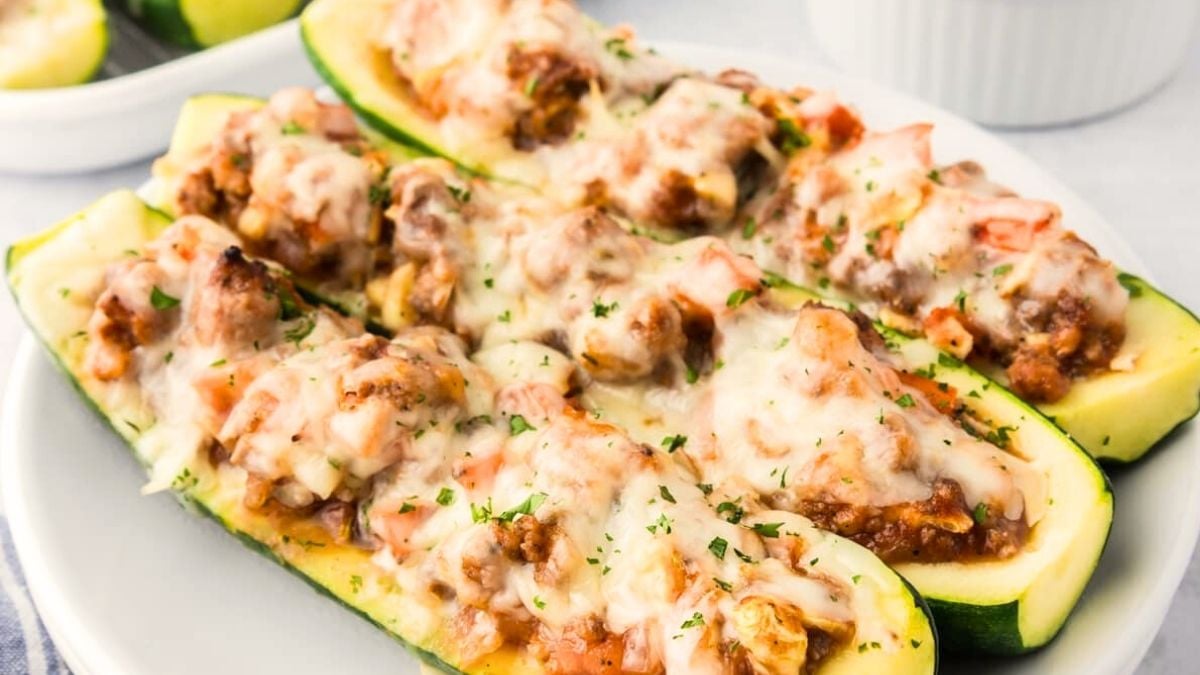 Zucchini boats on a white plate.