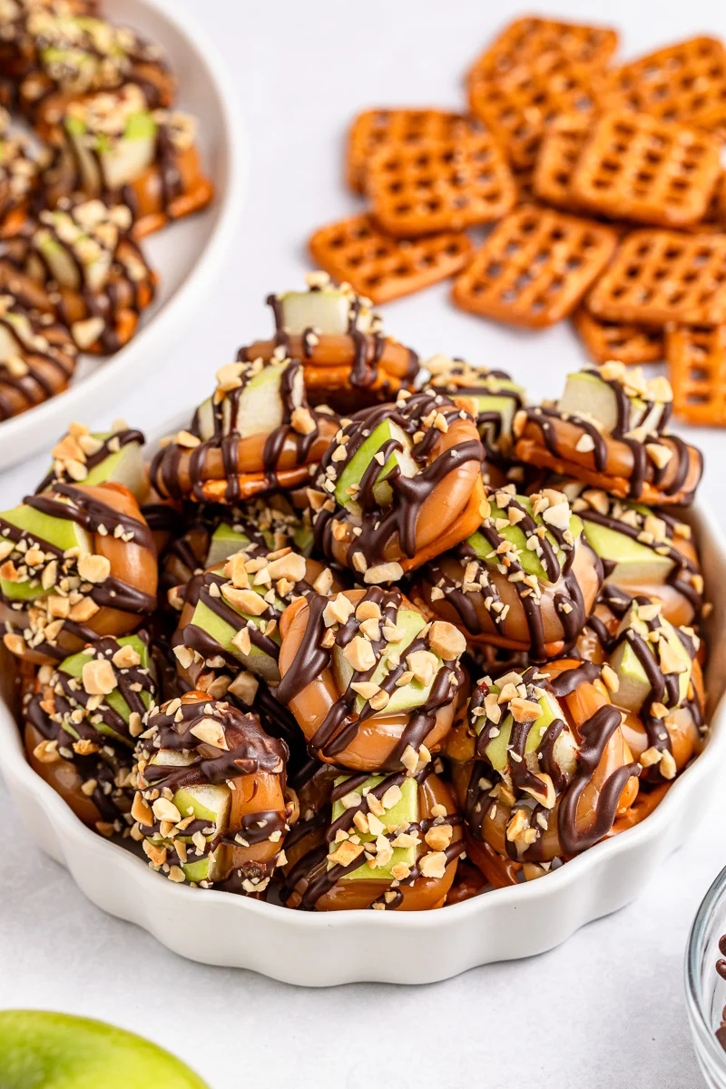Caramel apple pretzel bites served in a bowl.