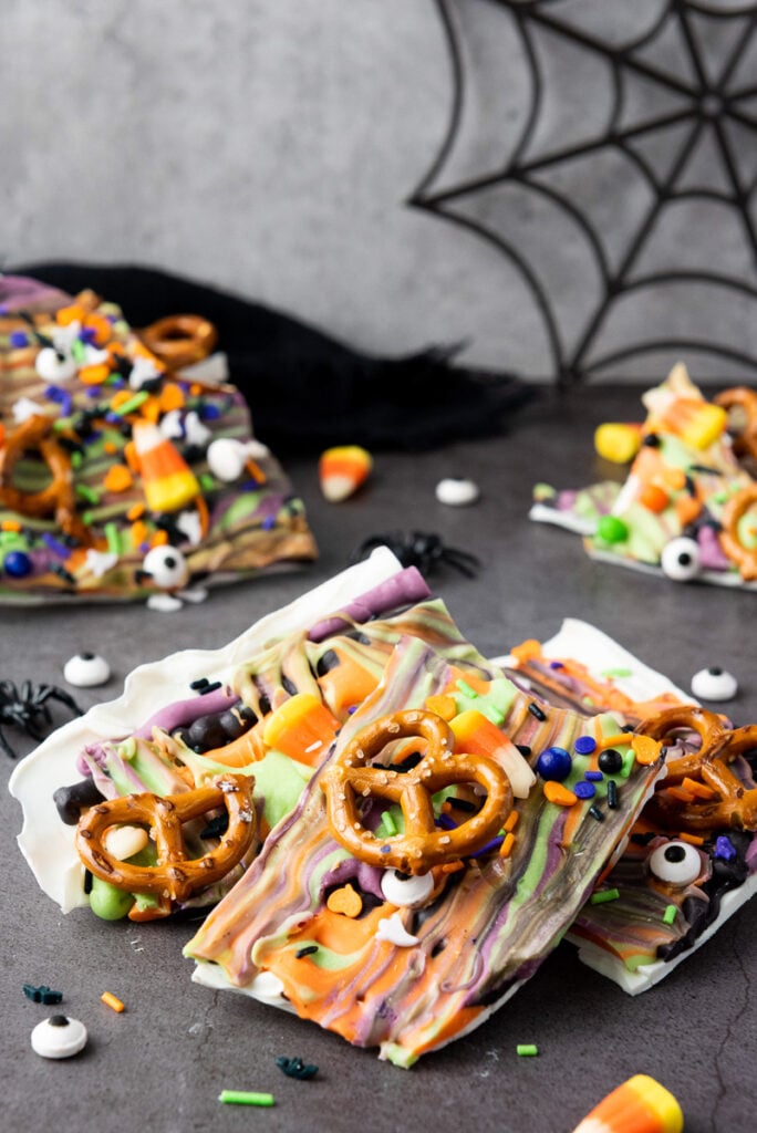 Pieces of Halloween bark with candy corn and pretzels.