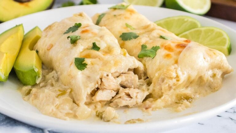 White chicken enchiladas on a white plate.