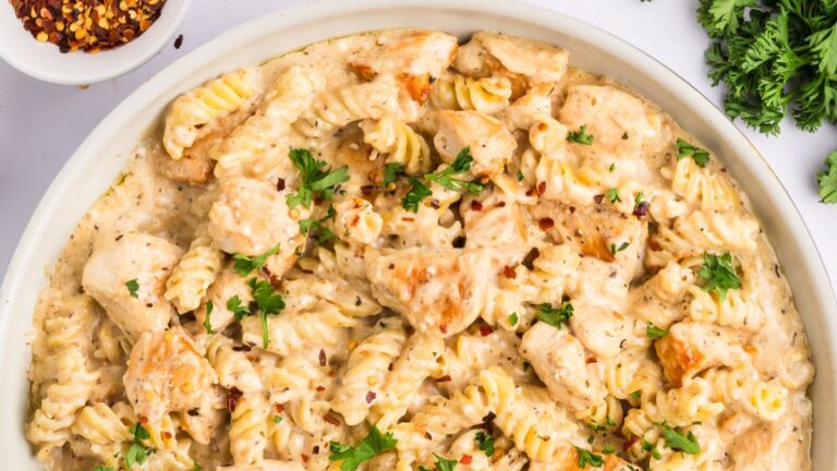 Chicken garlic parmesan pasta on a white plate.