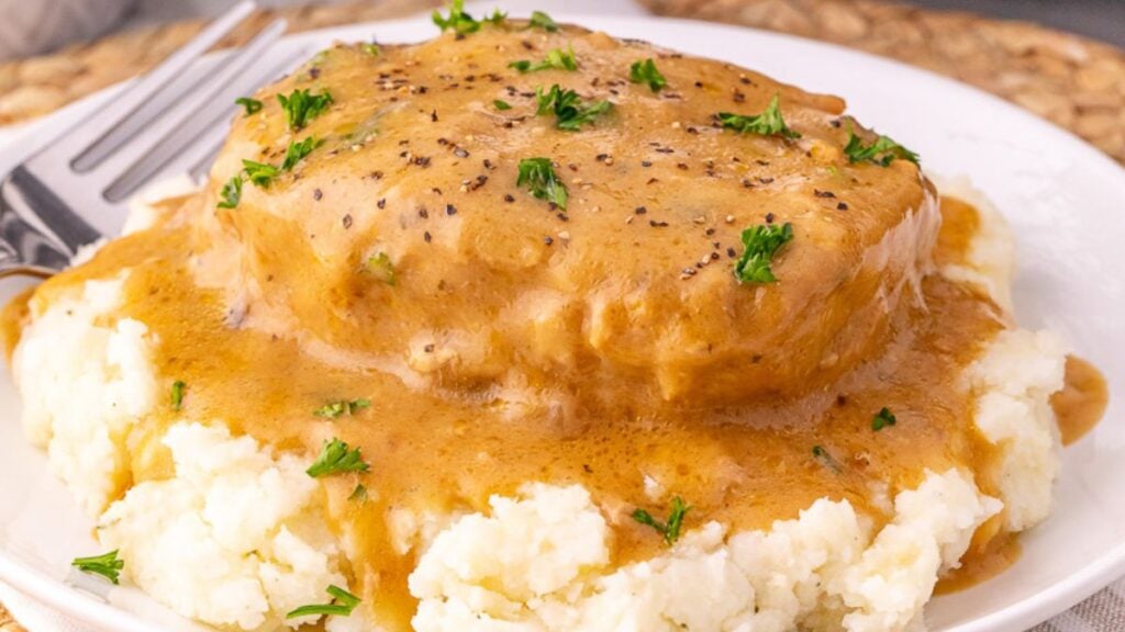 Creamy ranch pork chops served on a bed of mashed potatoes.