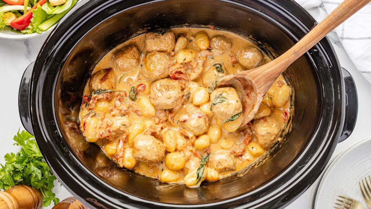 Slow cooker meatballs with gnocchi overhead view in crockpot.