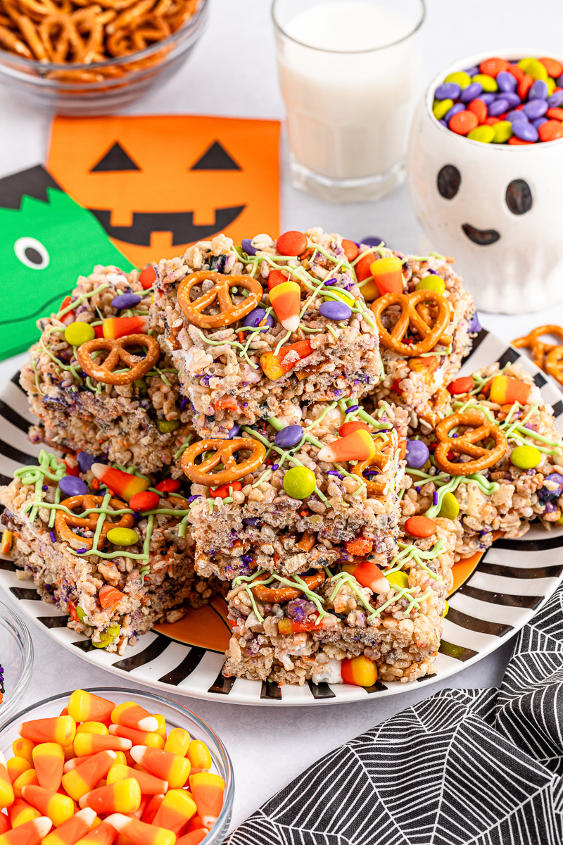 Halloween rice krisipie treats on a black and white plate.