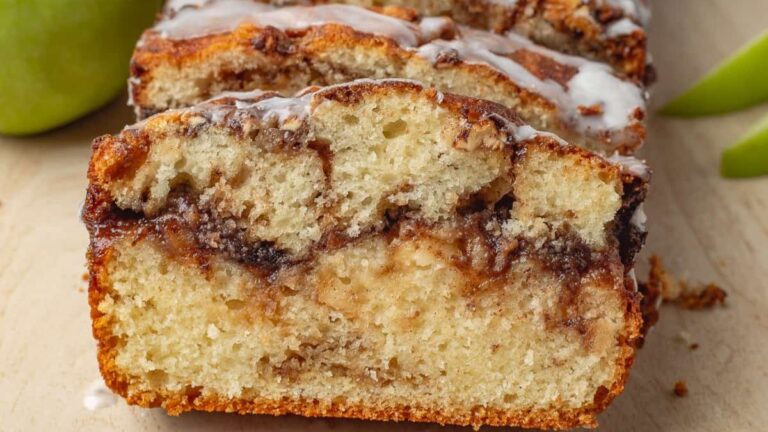 Apple fritter loaf cake on a wooden cutting board.