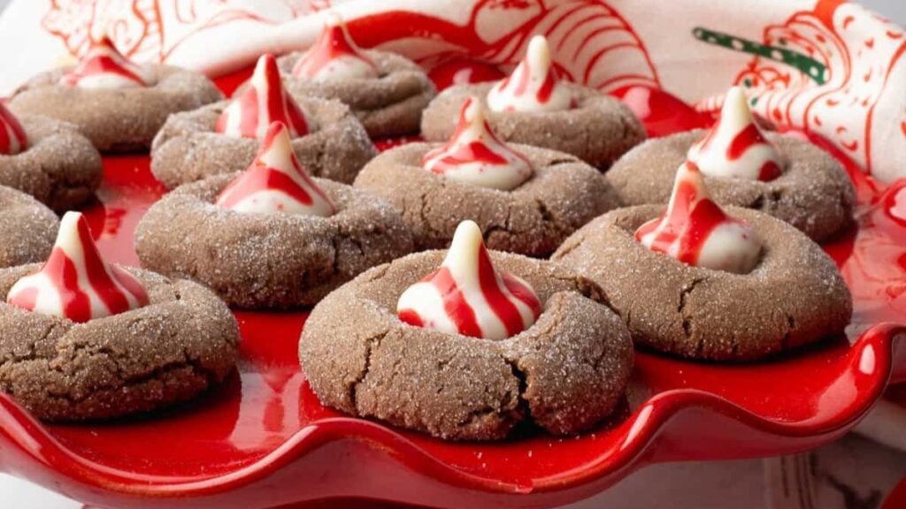 Chocolate peppermint blossoms on a red cookie tray.