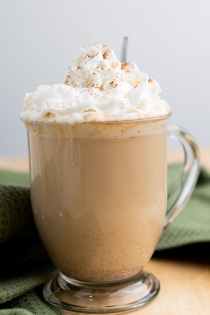 Pumpkin spice latte in glass mug.