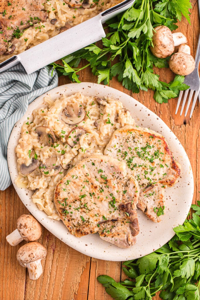 Vintage pork chop and rice casserole served on dinner plate.