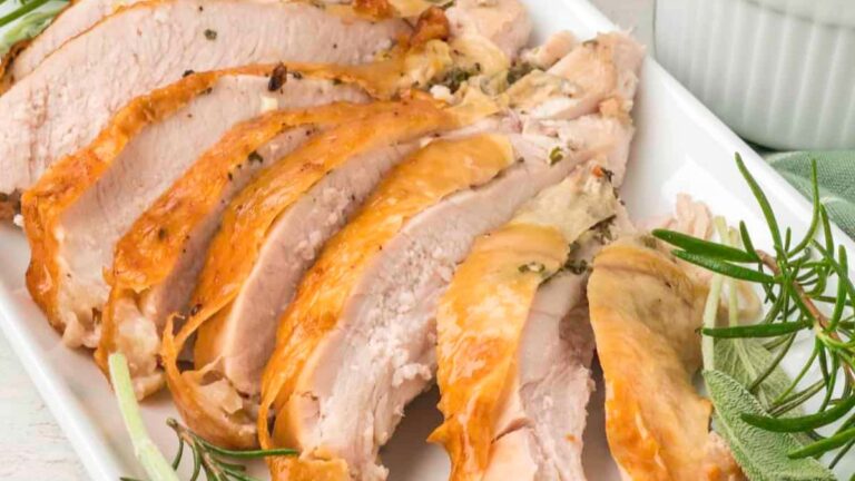 Turkey sliced on a white plate.