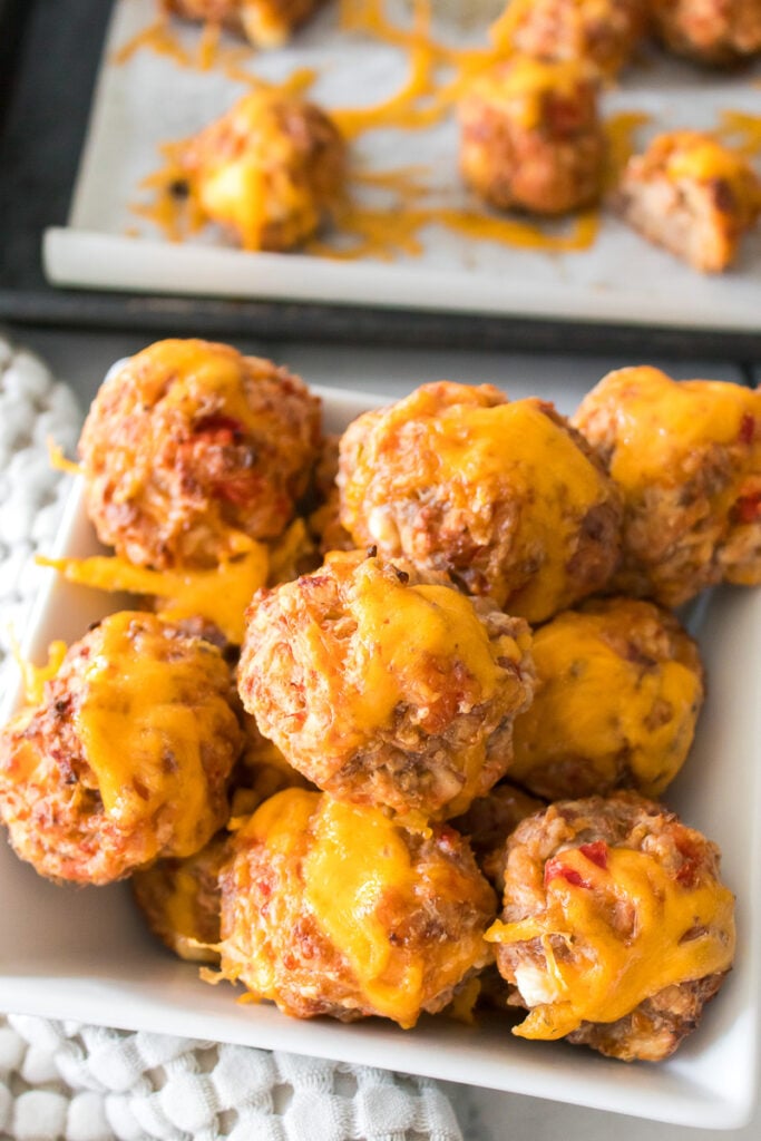 Sausage balls on a white platter for the holidays.