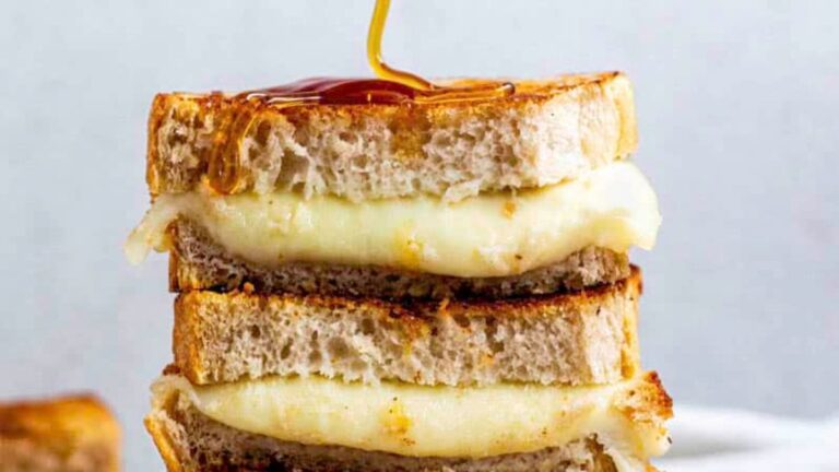 Grilled cheese sandwich on a plate.