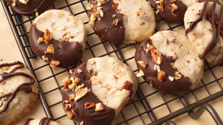 Pecan sandies, dipped in chocolate on wire cooling rack.