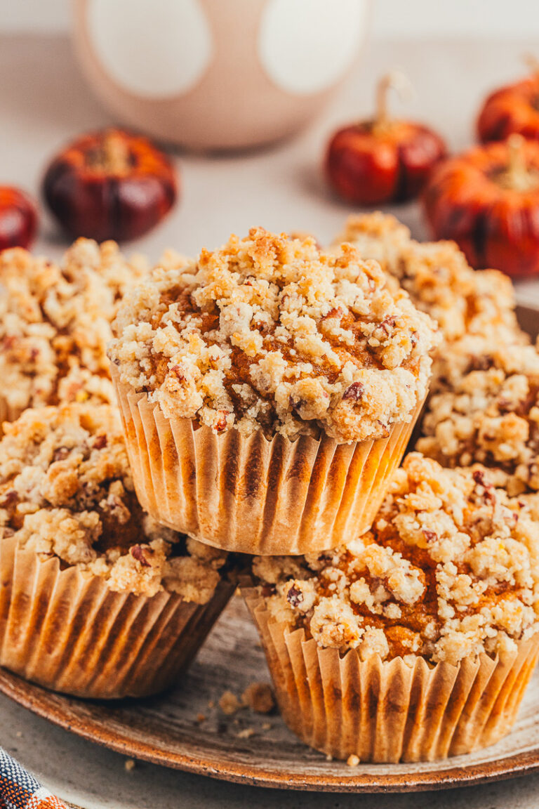Pumpkin streusel muffins on a white plate.