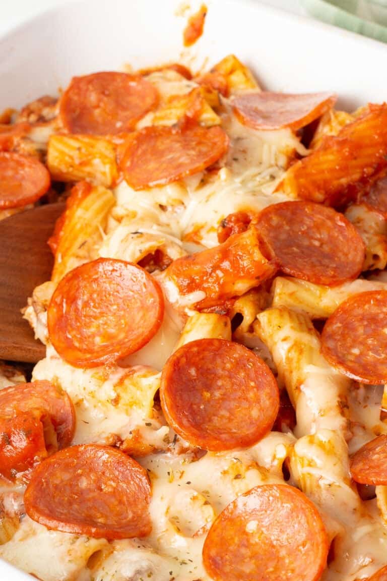 Pizza pasta bake with ground beef in casserole dish.