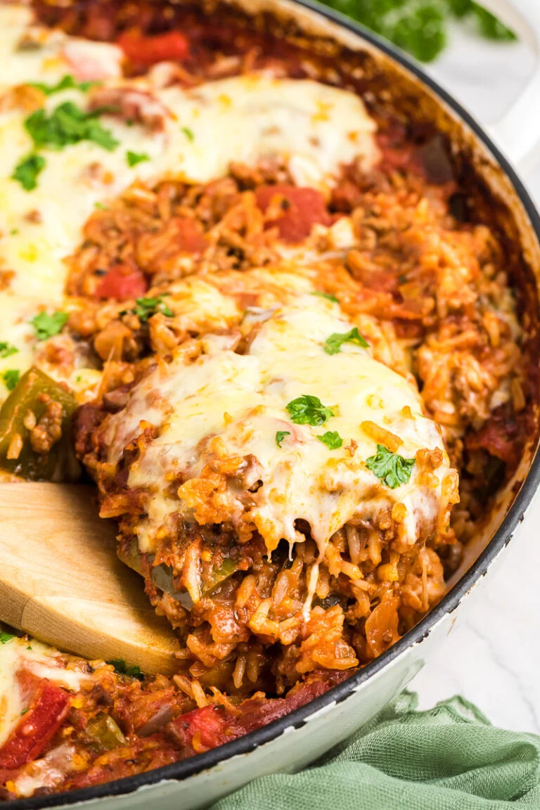 Stuffed pepper casserole scooped from baking dish onto a spoon.