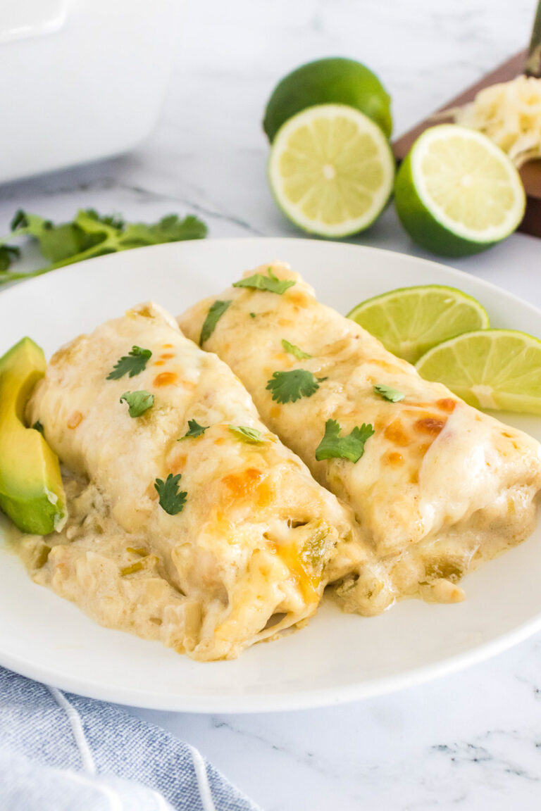 White chicken enchiladas on a white plate.