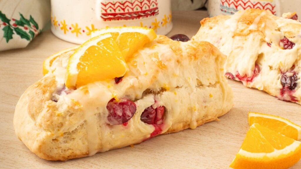Cranberry orange scones on a wooden board.