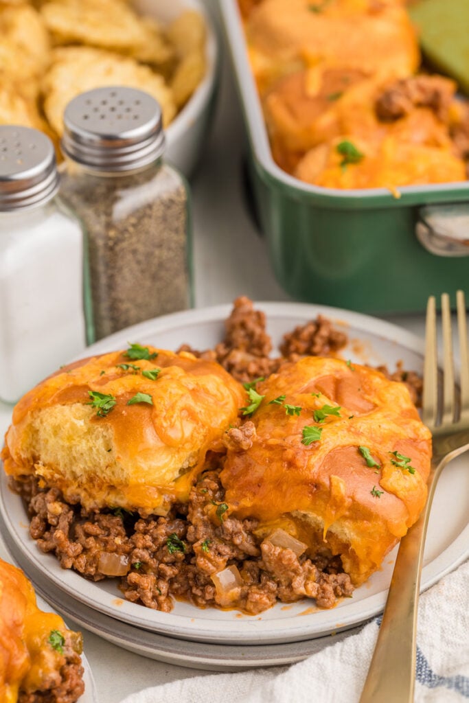 Sloppy Joe casserole with cheddar cheese on a white plate