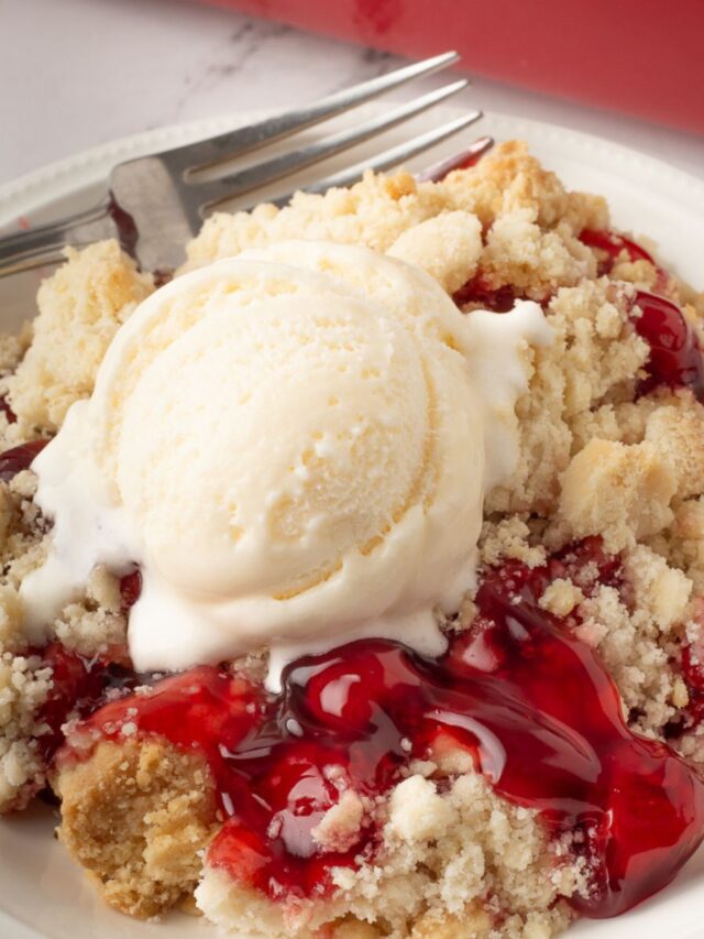 Cherry dump cake on a white plate.