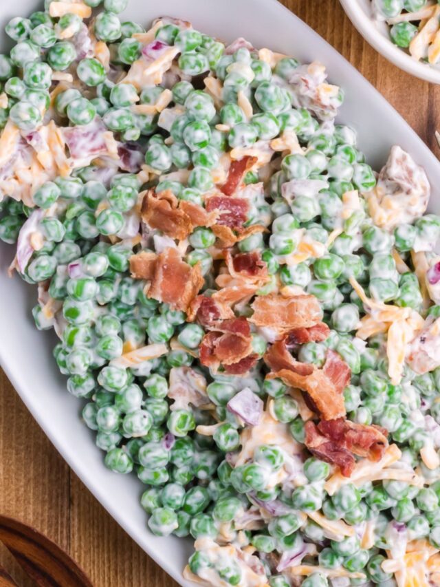 Pea salad with bacon served on a white plate.