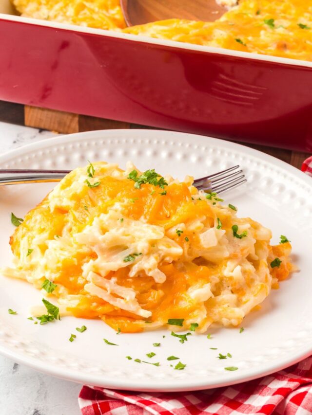 Cracker barrel hashbrown casserole served on a white plate with a fork.