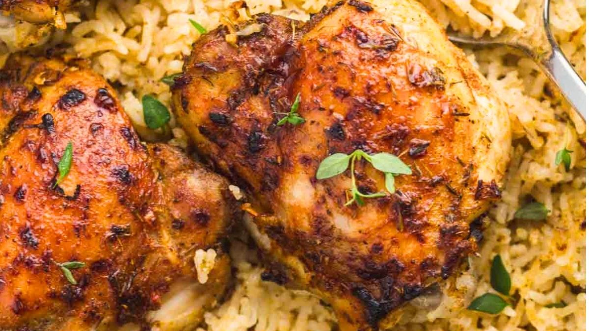 Close up image of oven bake chicken and rice.