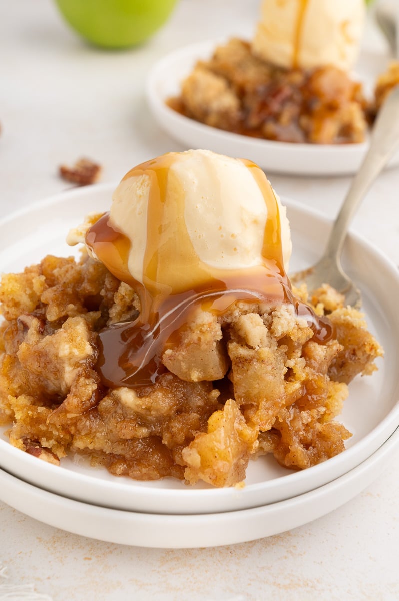 Caramel apple dump cake on a white plate.