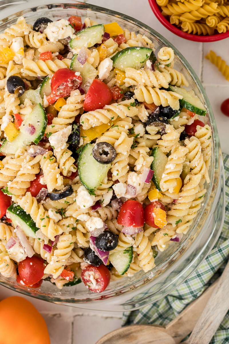 Greek pasta salad in a glass bowl.
