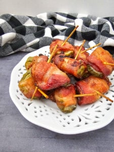 Air fryer bacon wrapped dilly bites served on a white plate.