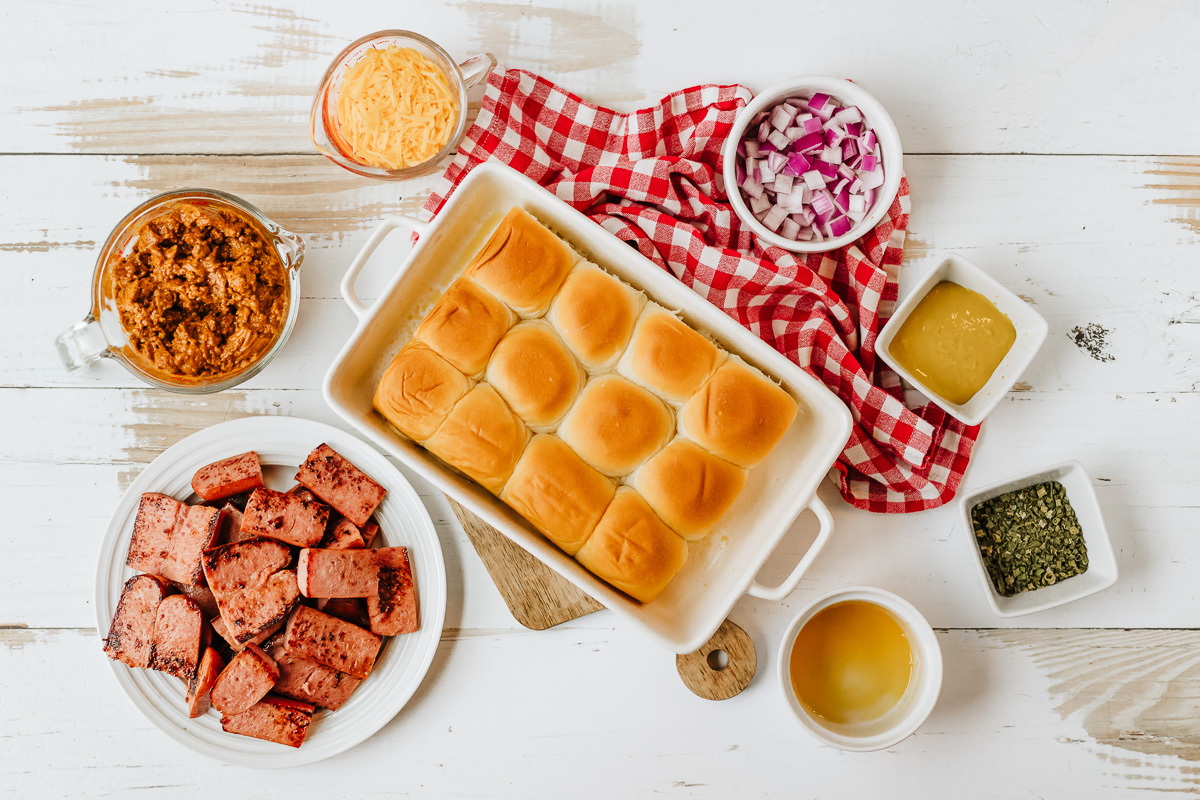 Ingredients for chii cheese dog sliders in small bowls on counter.