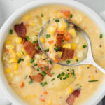Corn choweder in a bowl with a spoon.