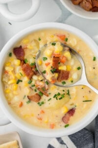 Corn choweder in a bowl with a spoon.