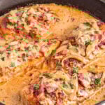 Smothered chicken in cast iron skillet.