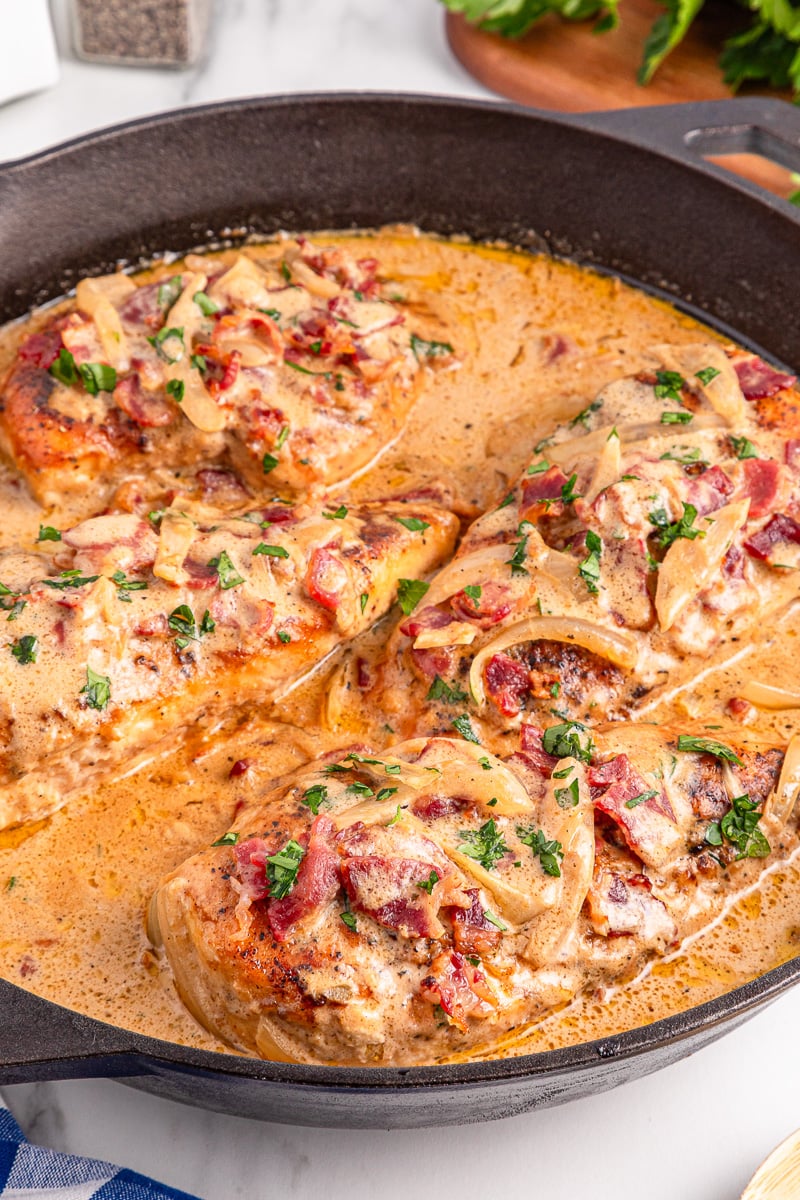 Smothered chicken in cast iron skillet.