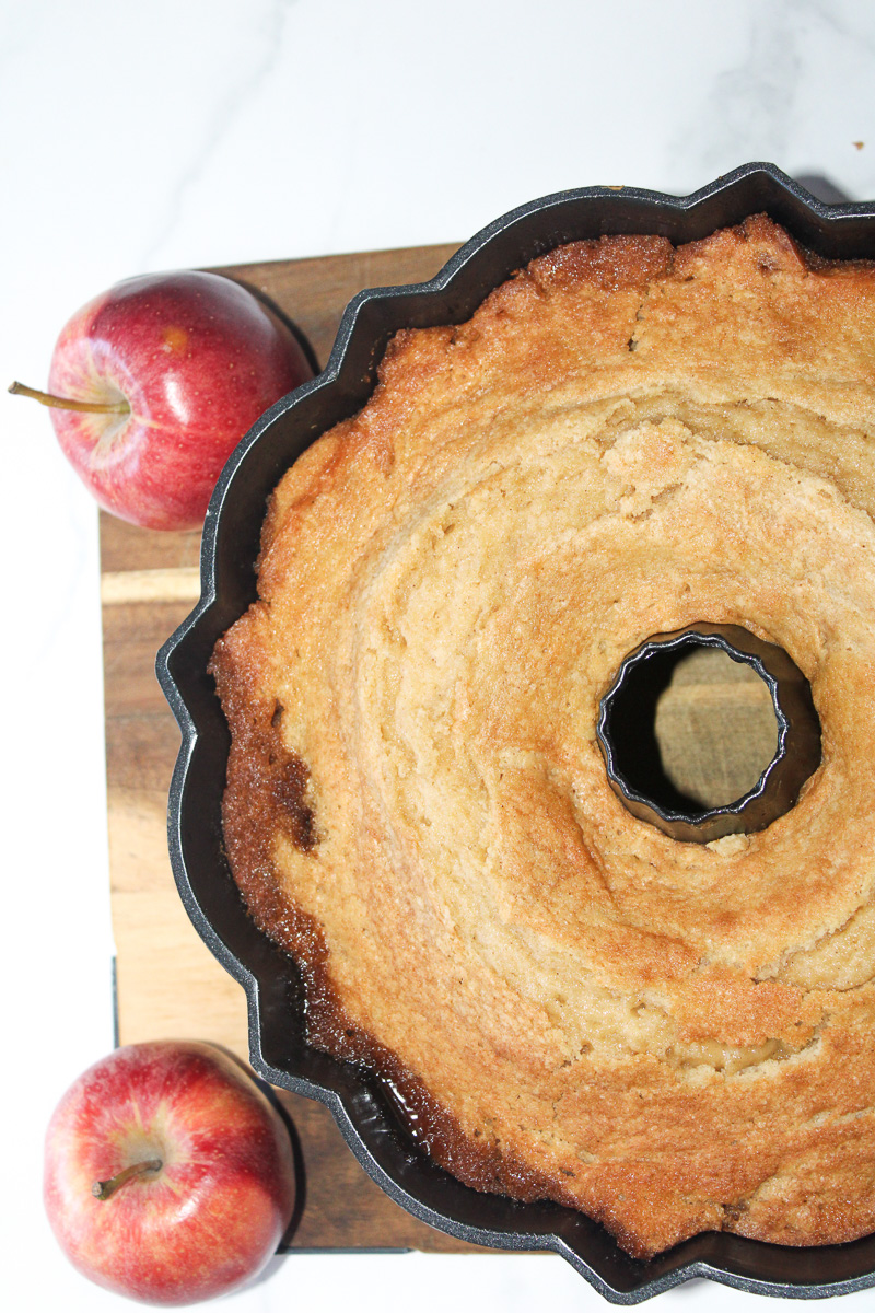 Baked apple cake on wire cooling rack.