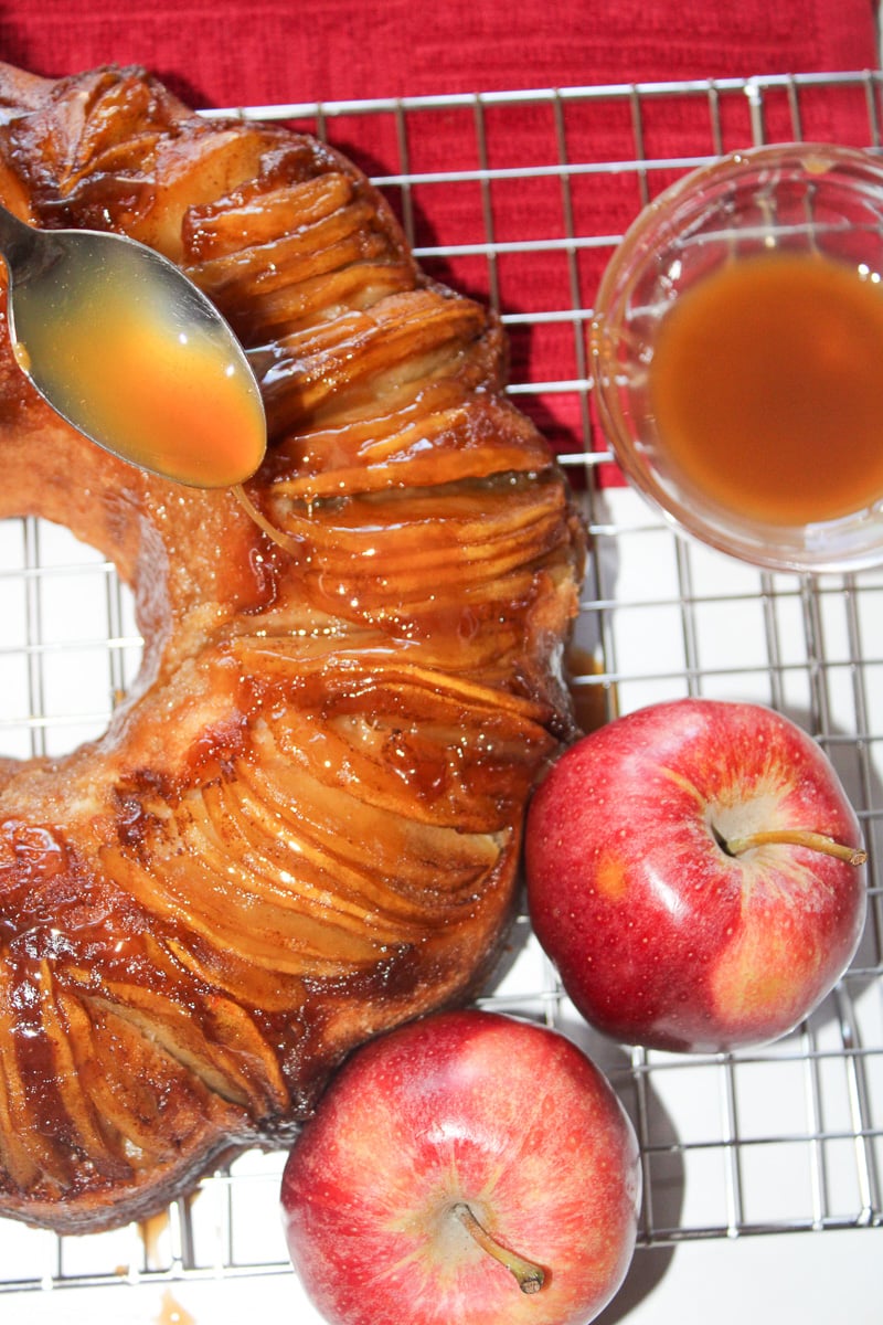 Caramel sauce is drizzled on top of the apple upside down cake.