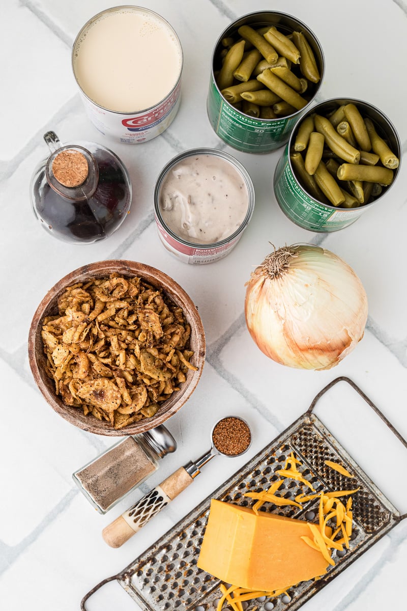Ingredients for green bean casserole laid out on counter in small bowls.