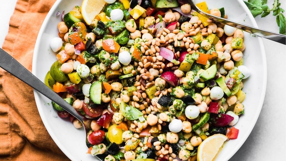 Chickpea salad with pesto on a white plate.