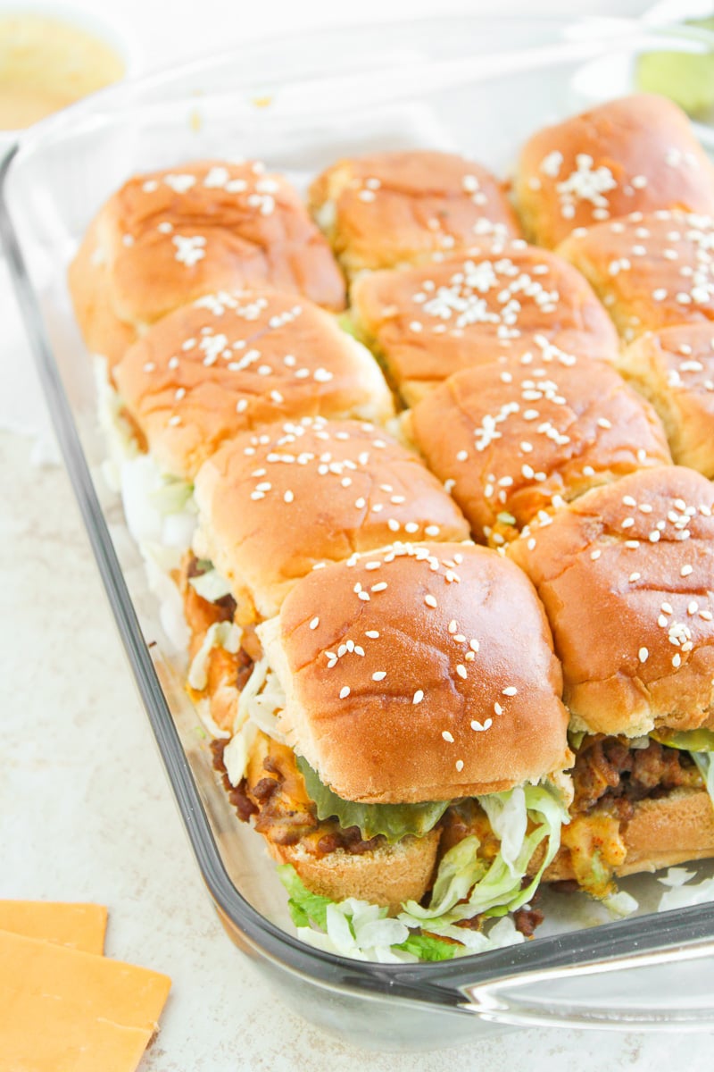 Finished dish of Big Mac sliders in glass baking dish.