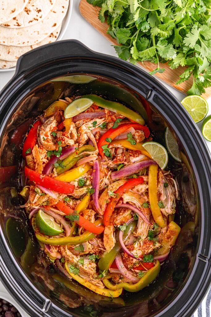 Slow cooker chicken fajitas in crockpot ready to be served.