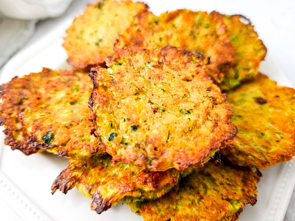 Finished dish of zucchini tots on white plate.