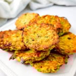 Zucchini tots on a white plate.
