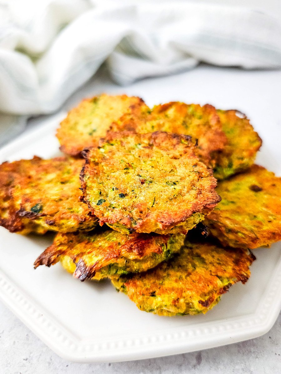 Zucchini tots on a white plate.
