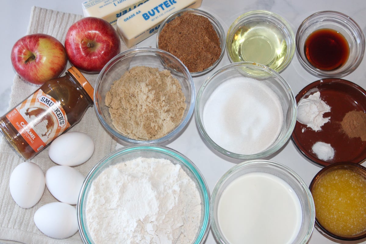 Ingredients for apple cake in small bowls on counter.